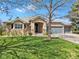 Charming ranch-style home with a well-manicured lawn, stone accents, and a welcoming three-car garage at 11 Canon Pl, Greenwood Village, CO 80111