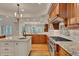 Gourmet kitchen featuring custom cabinets, granite countertops, high-end appliances, and a center island at 11 Canon Pl, Greenwood Village, CO 80111
