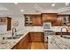 A gourmet kitchen featuring granite countertops, stainless steel appliances, and beautiful wood cabinetry at 11 Canon Pl, Greenwood Village, CO 80111