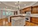 Open kitchen with island, granite countertops, stainless appliances, and wood floors at 11 Canon Pl, Greenwood Village, CO 80111