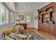 Inviting room with beautiful hardwood floors, plantation shutters, custom bookcase, and natural light at 11 Canon Pl, Greenwood Village, CO 80111