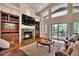 Comfortable living room with a fireplace, built-in shelving, large windows, and access to the outdoor deck at 11 Canon Pl, Greenwood Village, CO 80111