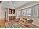 Cozy room with beautiful hardwood floors, a custom bookcase, comfortable chairs, and plenty of natural light at 11 Canon Pl, Greenwood Village, CO 80111