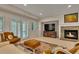Cozy living room with fireplace, french doors, recessed lights, and comfortable seating arrangements at 11 Canon Pl, Greenwood Village, CO 80111