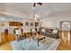 Spacious living room with open floor plan, hardwood floors, and views of the adjacent kitchen at 11 Canon Pl, Greenwood Village, CO 80111
