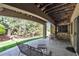 Covered patio with stone columns offering a cozy outdoor seating area with a view of the yard at 11 Canon Pl, Greenwood Village, CO 80111