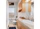 The bathroom features a classic design with wooden cabinets and a light-colored countertop and a white sink at 1450 N High St # 3, Denver, CO 80218