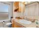 The bathroom features a classic design with wooden cabinets and a light-colored countertop and a white sink at 1450 N High St # 3, Denver, CO 80218