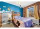 Comfortable bedroom with blue accent wall, exposed brick, and ample natural light at 1450 N High St # 3, Denver, CO 80218