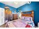 The bedroom has wooden accents, a custom mountain paint job, and an adventure-themed decor at 1450 N High St # 3, Denver, CO 80218
