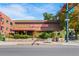 The building has red signage that says Dazbog Coffee and is in a mixed-use walkable neighborhood at 1450 N High St # 3, Denver, CO 80218