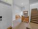 The entryway has carpeted stairs and a beautiful wood banister and a window providing natural light at 1450 N High St # 3, Denver, CO 80218