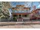 Charming three-story home featuring a covered front porch and mature trees at 1450 N High St # 3, Denver, CO 80218