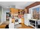 Efficient kitchen boasts wood cabinets, tile backsplash, and an adjacent dining area at 1450 N High St # 3, Denver, CO 80218