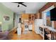 Efficient kitchen boasts wood cabinets, tile backsplash, and an adjacent dining area at 1450 N High St # 3, Denver, CO 80218