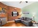 Inviting living area with exposed brick, hardwood floors, and comfortable seating at 1450 N High St # 3, Denver, CO 80218