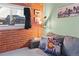 Relaxing living area with exposed brick, hardwood floors, and comfortable furnishings at 1450 N High St # 3, Denver, CO 80218
