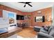 Cozy living space with exposed brick, hardwood floors, and lots of natural light at 1450 N High St # 3, Denver, CO 80218