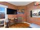 Cozy living space featuring exposed brick, hardwood floors, and exposed radiator at 1450 N High St # 3, Denver, CO 80218