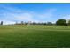 The park has a vast expanse of green grass and trees in the distance providing a relaxing outdoor space at 1450 N High St # 3, Denver, CO 80218