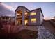 Beautiful two-story home with a covered deck, stone landscaping, and sunset views at 6728 Mentha Dr, Castle Rock, CO 80108