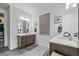 Well-lit bathroom featuring dual vanities, modern fixtures, and stylish gray tile flooring at 6728 Mentha Dr, Castle Rock, CO 80108