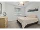 Cozy bedroom features carpet flooring, a ceiling fan, a large window, and natural light at 6728 Mentha Dr, Castle Rock, CO 80108