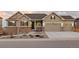 Charming exterior of this two-story home featuring a three car garage and beautifully landscaped front yard at 6728 Mentha Dr, Castle Rock, CO 80108