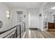 Bright foyer with wood flooring, featuring a modern light fixture and easy access to the study at 6728 Mentha Dr, Castle Rock, CO 80108