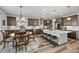 Spacious kitchen with central island and an adjacent dining area with stylish chandelier at 6728 Mentha Dr, Castle Rock, CO 80108