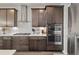 Modern kitchen featuring stainless steel appliances and wooden cabinets at 6728 Mentha Dr, Castle Rock, CO 80108