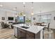 Open-concept kitchen features a central island that looks out into the living room at 6728 Mentha Dr, Castle Rock, CO 80108