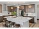 An open kitchen displays a large island with seating and stainless steel appliances at 6728 Mentha Dr, Castle Rock, CO 80108