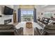 Inviting living room with a fireplace and a view of the outdoor deck through large sliding glass doors at 6728 Mentha Dr, Castle Rock, CO 80108