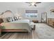 Spacious main bedroom featuring a ceiling fan, a large window, and neutral decor at 6728 Mentha Dr, Castle Rock, CO 80108