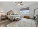 Bright main bedroom features a ceiling fan, and a large window providing natural light at 6728 Mentha Dr, Castle Rock, CO 80108