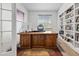 Well-lit office space with a spacious desk and custom built-in shelving for storage and display at 6728 Mentha Dr, Castle Rock, CO 80108