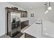 Spacious pantry featuring stainless steel refrigerator, ample cabinet space, and modern lighting at 6728 Mentha Dr, Castle Rock, CO 80108