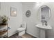 Stylish powder room features a pedestal sink, modern toilet, and neutral wall decor at 6728 Mentha Dr, Castle Rock, CO 80108