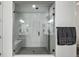 Modern tiled shower featuring a glass enclosure, seating, and contemporary fixtures at 6728 Mentha Dr, Castle Rock, CO 80108