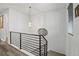 Open staircase featuring modern metal railings and light-colored wood flooring on the upper level at 6728 Mentha Dr, Castle Rock, CO 80108