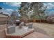 Backyard features a cozy outdoor space with a grill, fire pit, and mature landscaping at 1549 S Evanston St, Aurora, CO 80012