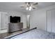 Bedroom features a light gray dresser, ceiling fan, wood-look floors, and ensuite bathroom at 1549 S Evanston St, Aurora, CO 80012