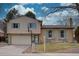 Charming two-story home with a combination of siding and brick, complemented by delightful blue shutters at 1549 S Evanston St, Aurora, CO 80012