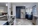 Modern kitchen featuring navy cabinets, stainless steel appliances, and pantry space at 1549 S Evanston St, Aurora, CO 80012