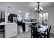 Modern kitchen with stylish cabinets, a central island, and a spacious dining area at 1549 S Evanston St, Aurora, CO 80012