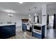 Modern kitchen with stainless steel oven with cooktop and seamlessly connects to the living room at 1549 S Evanston St, Aurora, CO 80012