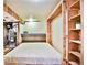 Finished basement bedroom with a murphy bed and shelving at 1641 S Idalia Cir # F, Aurora, CO 80017