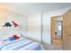 Well-lit bedroom featuring a door to another room, and dinosaur-themed décor at 1641 S Idalia Cir # F, Aurora, CO 80017