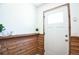 Inviting entryway with wood-paneled walls, a white door and small plants at 1641 S Idalia Cir # F, Aurora, CO 80017